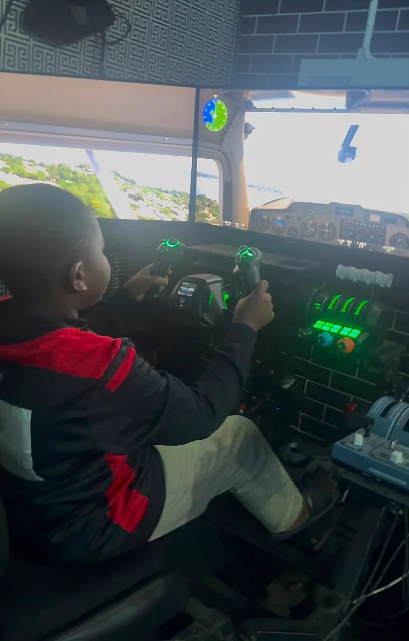 Child using the Player One flight simulator during a supervised GameEdu activity
