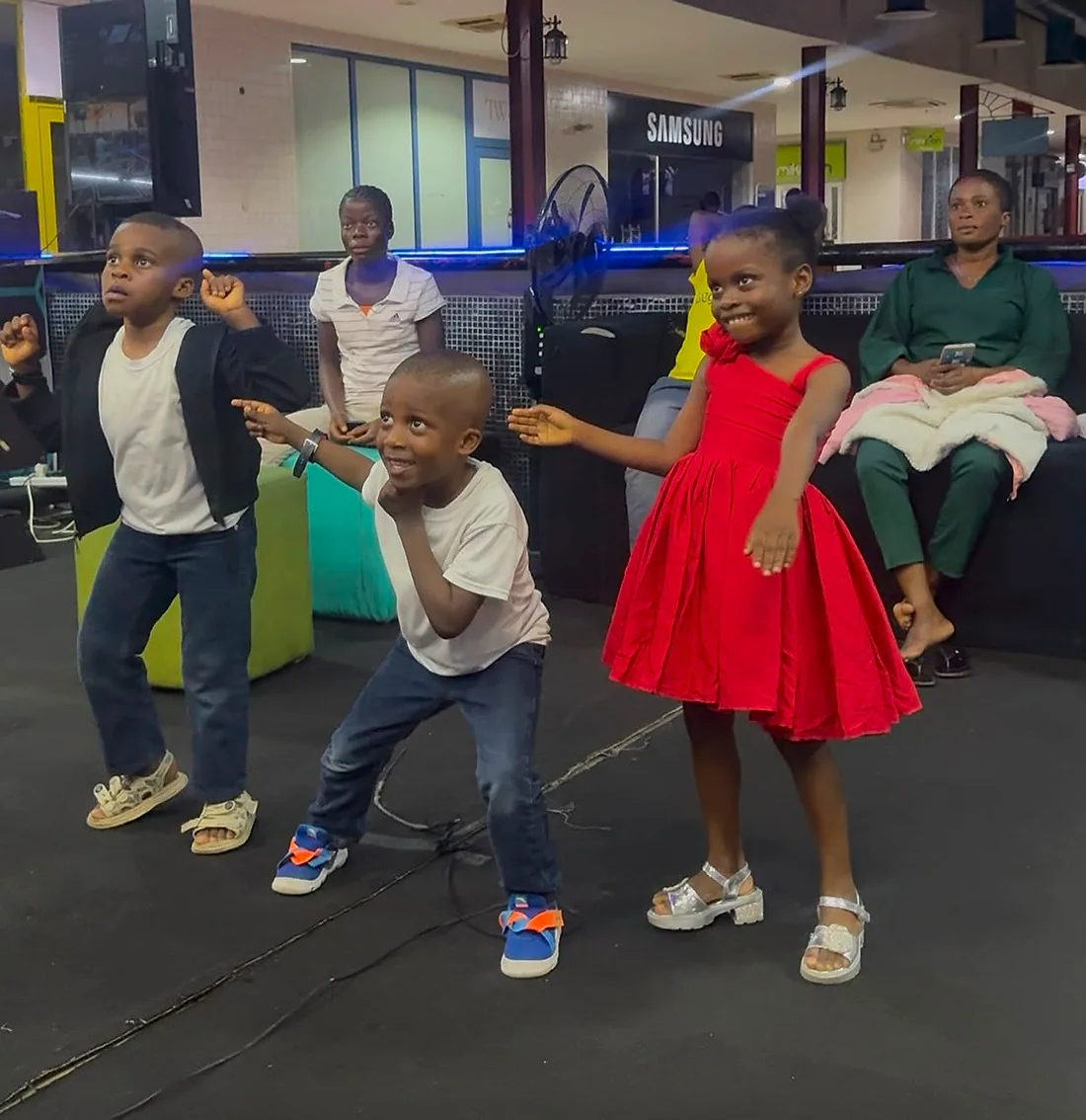 Excited children dancing and playing together at Player One