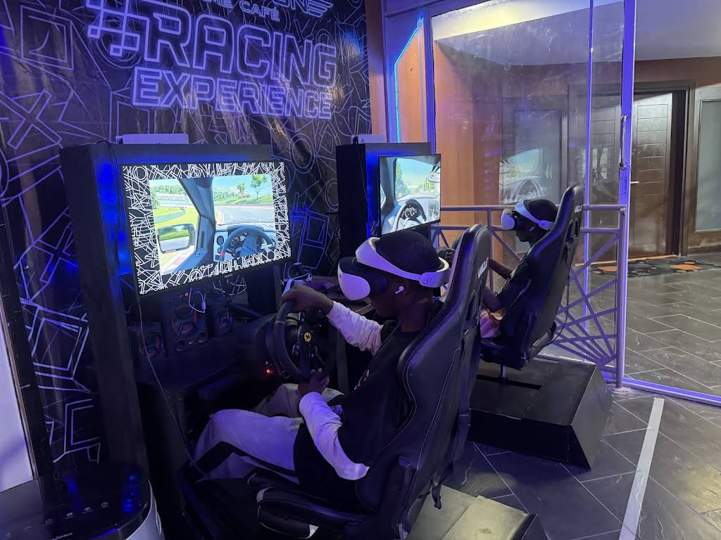 Two players wearing VR headsets and racing side by side at Player One Victoria Island