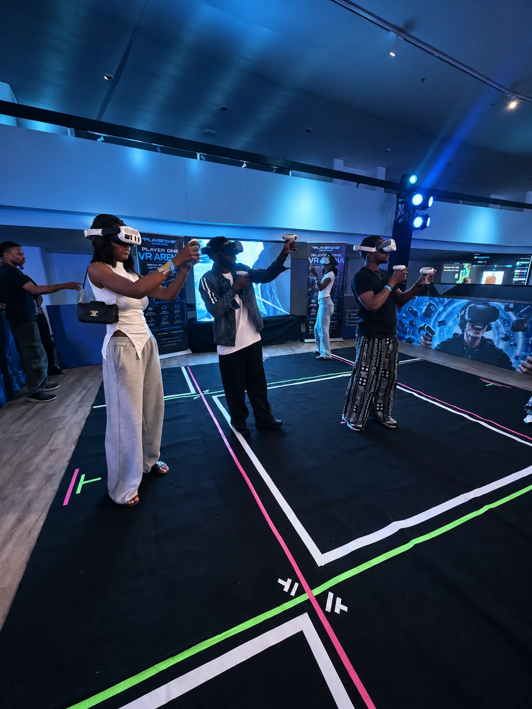 A group playing in a real Player One VR arena, with edited lighting