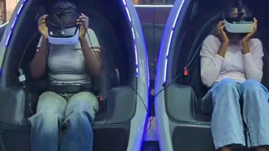 Two guests sharing a VR pod date night experience at Player One Game Cafe Lagos