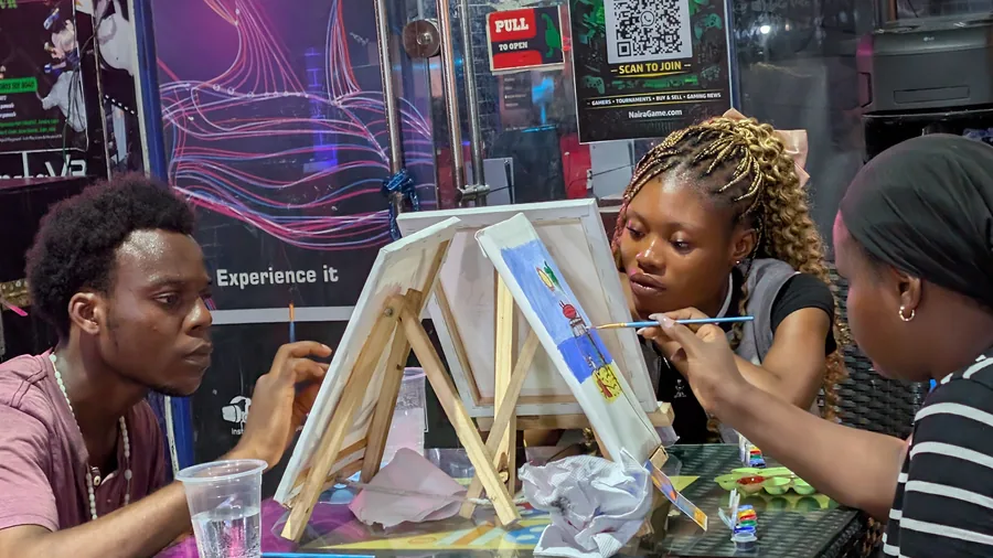 Paint Sip Play guests painting canvases at Player One Game Cafe