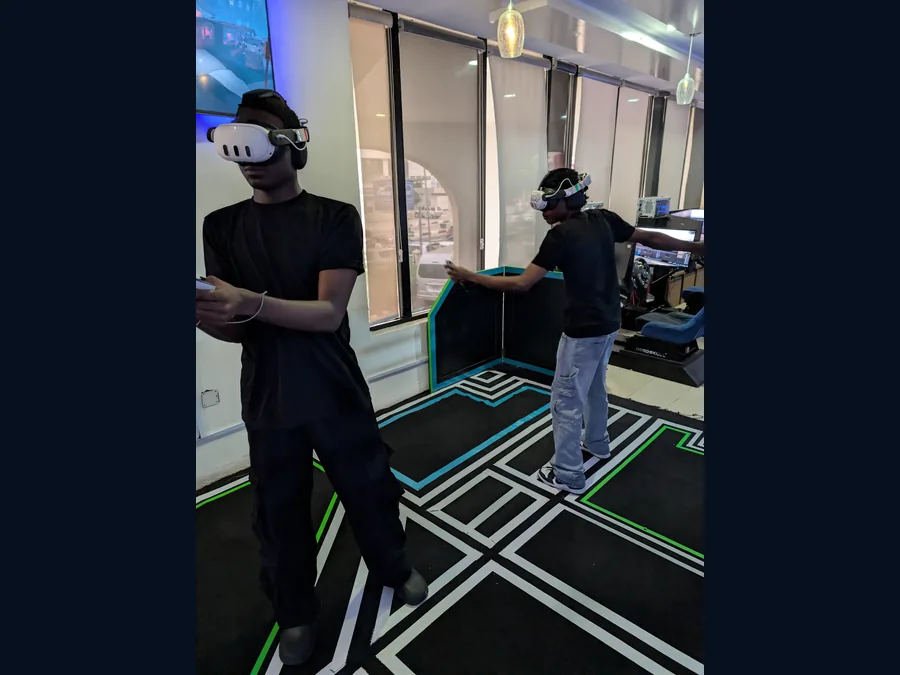 Two players moving together in a free-roam multiplayer VR arena